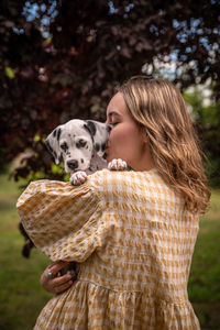Young woman with a dalmatian puppy