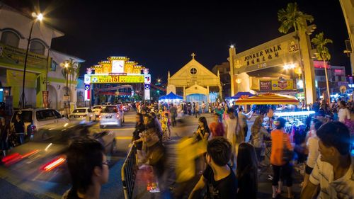 People walking on city street at night
