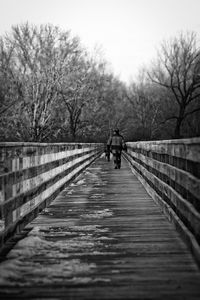 Woman walking on footbridge