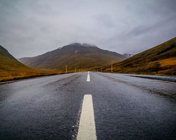 Road amidst mountains against sky