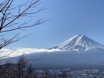 Scenic view of snowcapped mountains against blue sky