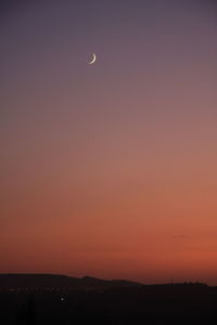 Scenic view of moon against sky at sunset