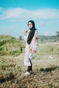 Young woman standing on field