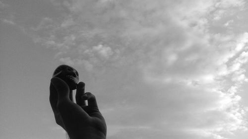 Man photographing camera against sky