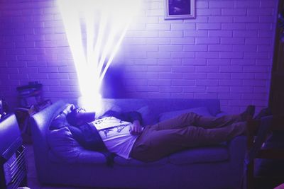 Man sleeping on sofa at home
