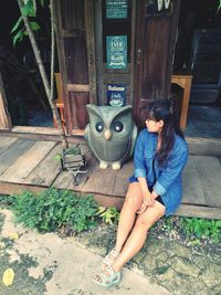 High angle view of woman sitting against building