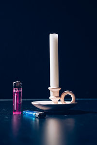 Close-up of telephone booth on table against black background