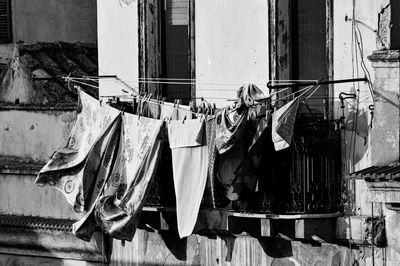 Clothes drying on rope against building