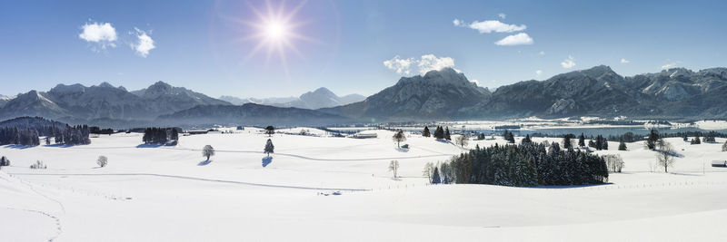 Panoramic view of snow covered mountains against sky