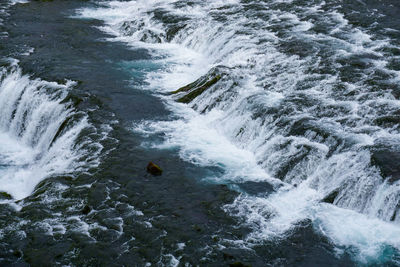 High angle view of water flowing over rocks