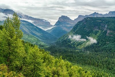 Scenic view of valley and mountains against sky