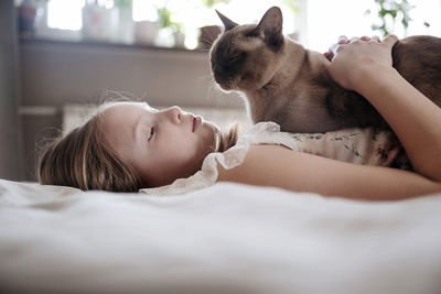 Close-up of boy sleeping on bed at home