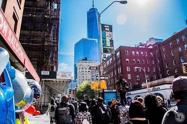 building exterior, architecture, built structure, city, skyscraper, large group of people, modern, office building, city life, tall - high, men, tower, lifestyles, person, building, street, sky, capital cities, leisure activity