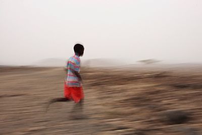 Full length of woman standing on landscape