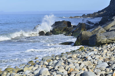 Waves splashing on rocks at shore