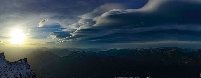 Scenic view of snowcapped mountains against dramatic sky