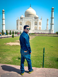 Full length of man standing against historic building