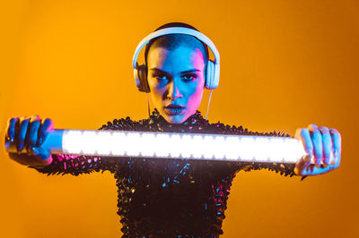 Portrait of young man against illuminated background