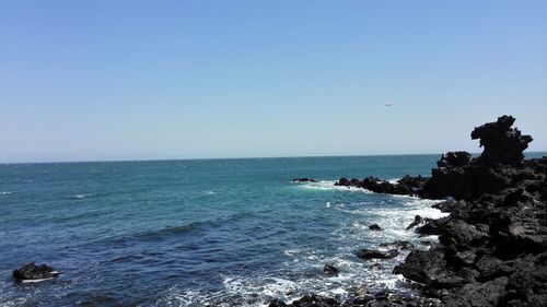 Scenic view of sea against clear blue sky