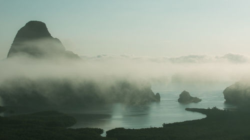 Scenic view of sea and mountains against sky