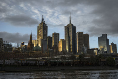 Cityscape against cloudy sky