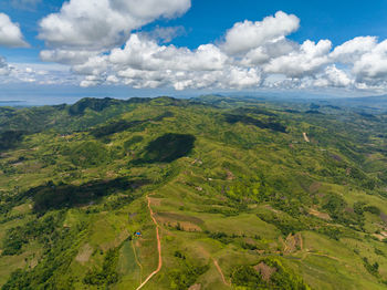 Farmland on a background of blue sky and clouds in a mountainous area. negros, philippines