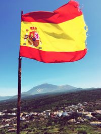 Scenic view of flag against clear blue sky