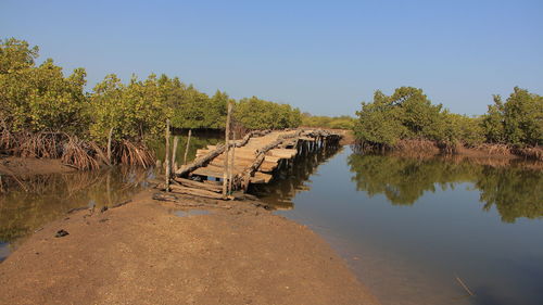 Arch bridge over river against sky