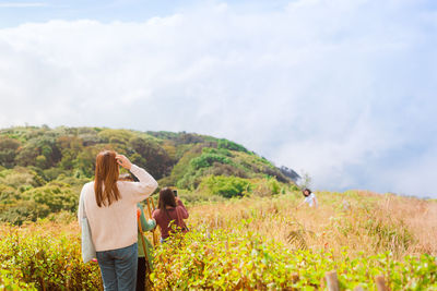 Group asian woman traveler hiking and embracing nature from top of mountain in spring season