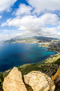 Aerial view of sea against cloudy sky