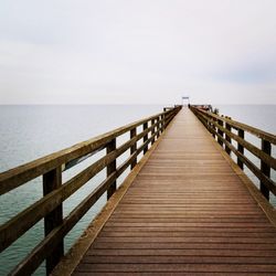 Pier over sea against clear sky