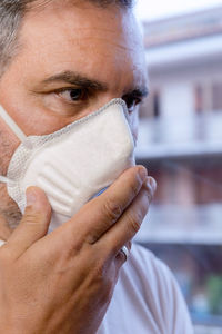 A man with a protective medical mask waits for the end of the covid-19 emergency quarantine.