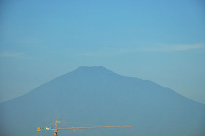 Crane against majestic mountain