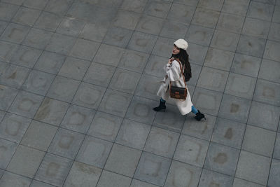 High angle view of woman walking on street