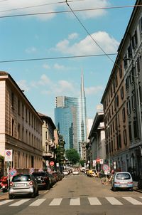 City street and buildings against sky