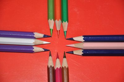 Close-up of colored pencils against yellow background