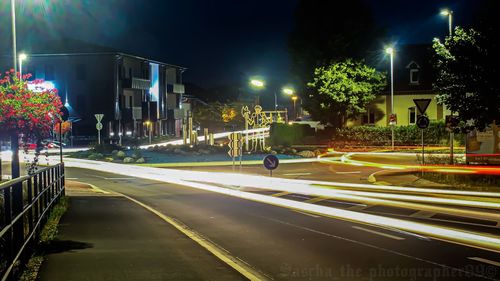 Light trails on road in city at night