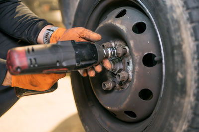 Close-up of man working on metal