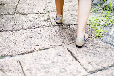 Woman feet walking on the sidewalk