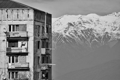 Snow covered buildings against sky