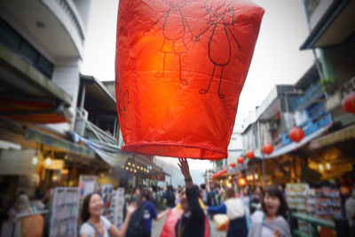 Low angle view of lanterns hanging over buildings
