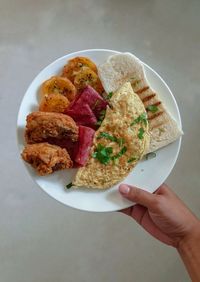 High angle view of person preparing food in plate