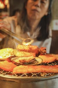 Close-up of woman eating food in restaurant