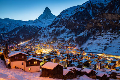 Snow covered houses and buildings in city during winter