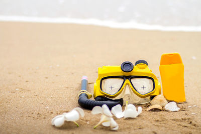 Close-up of shoes on beach