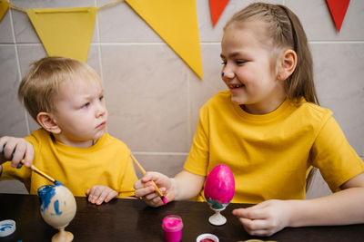 Brother and sister color easter eggs