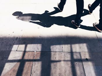 Low section of men walking on road