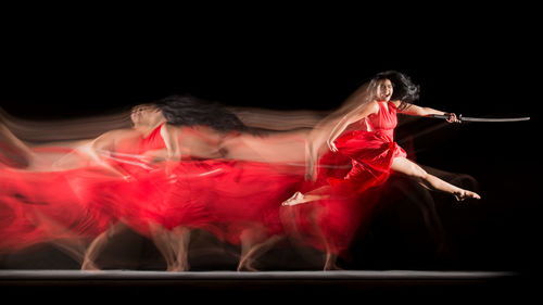 Digital composite image of women dancing against black background
