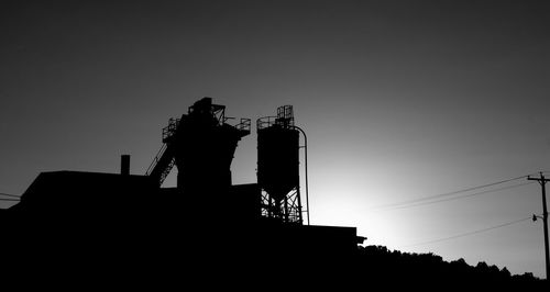 Low angle view of silhouette built structure against sky