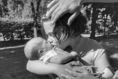 Sister kissing brother in park